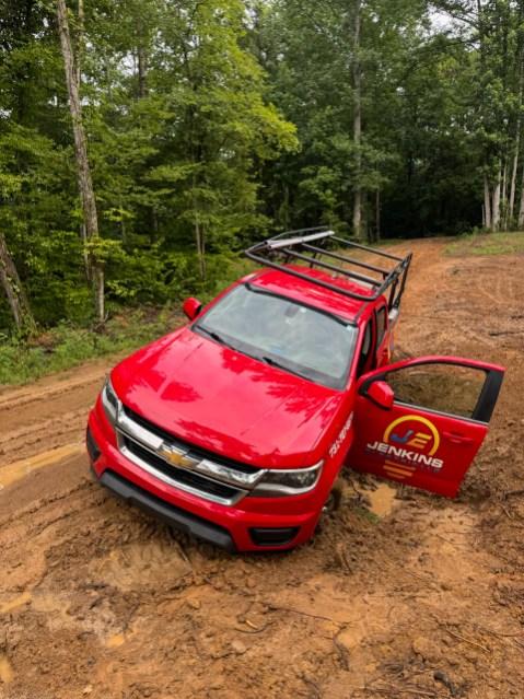 Image of a red truck stuck in the mud